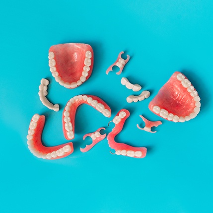 assorted types of dentures against a blue background