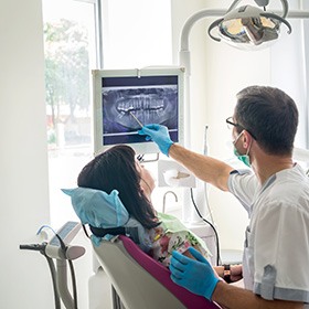 dentist showing his patient her X-rays