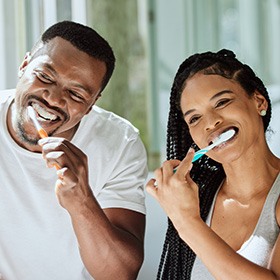 a couple brushing their teeth together