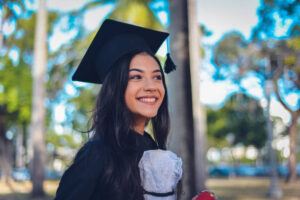 Smiling woman in cap and gown
