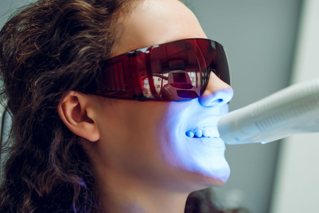 A woman getting a professional whitening treatment.