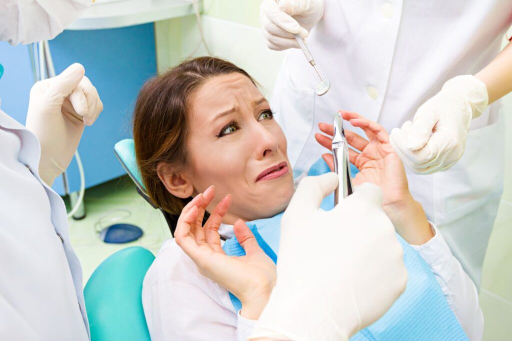 A fearful woman in a dentist’s chair 